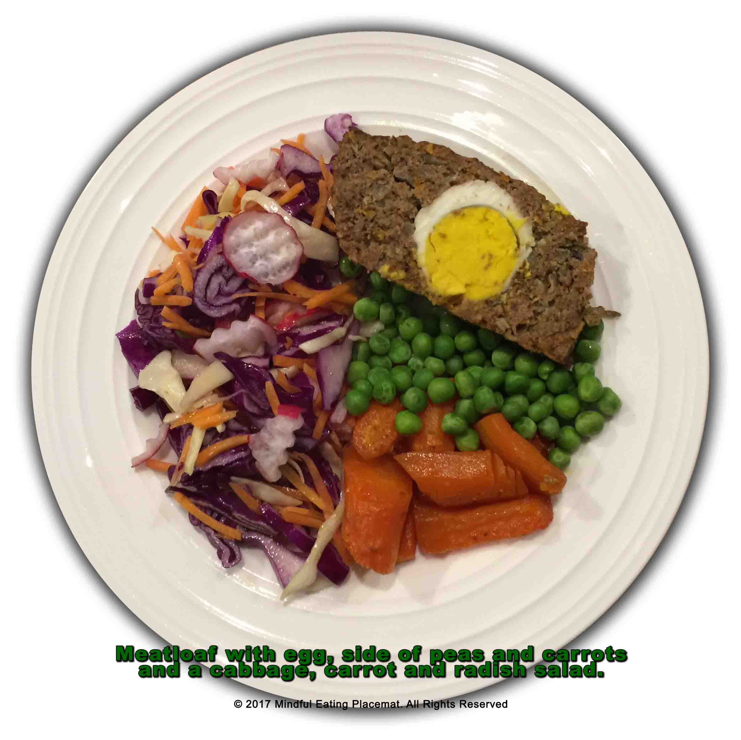 Meatloaf with egg and a side of peas and carrots with a salad