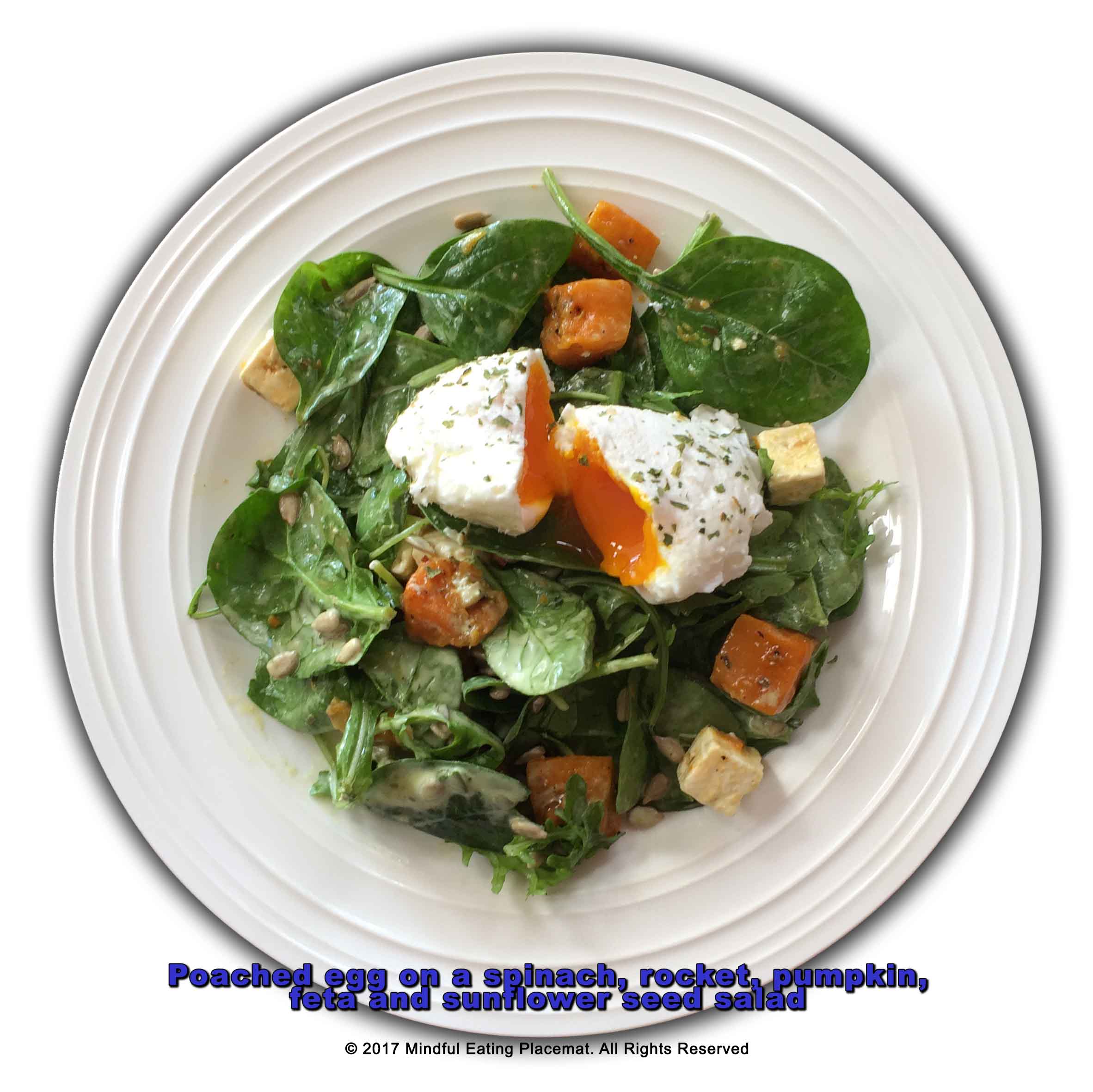 Poached egg on a spinach, rocket, pumpkin, feta and sunflower seed salad