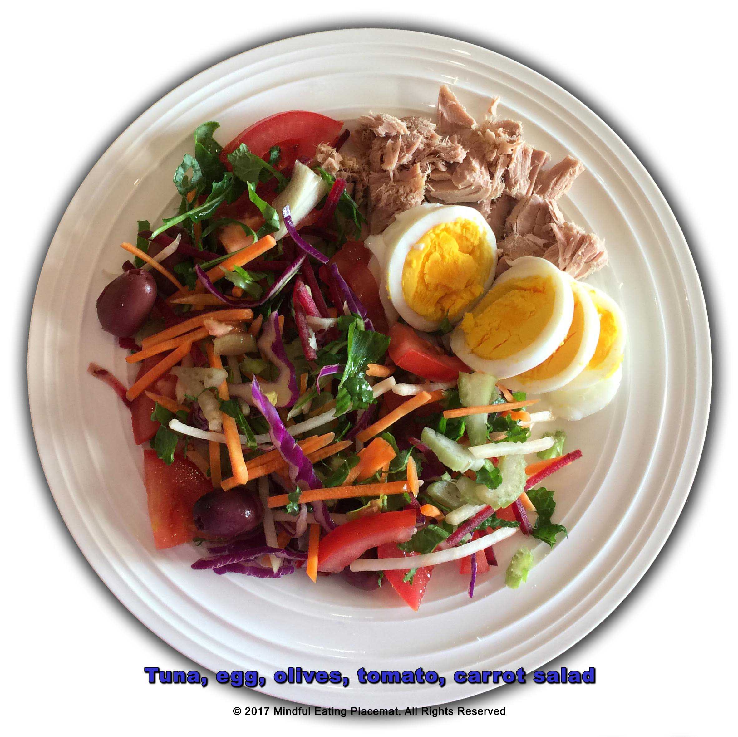 Tuna, boiled egg, olives, tomato and carrot salad
