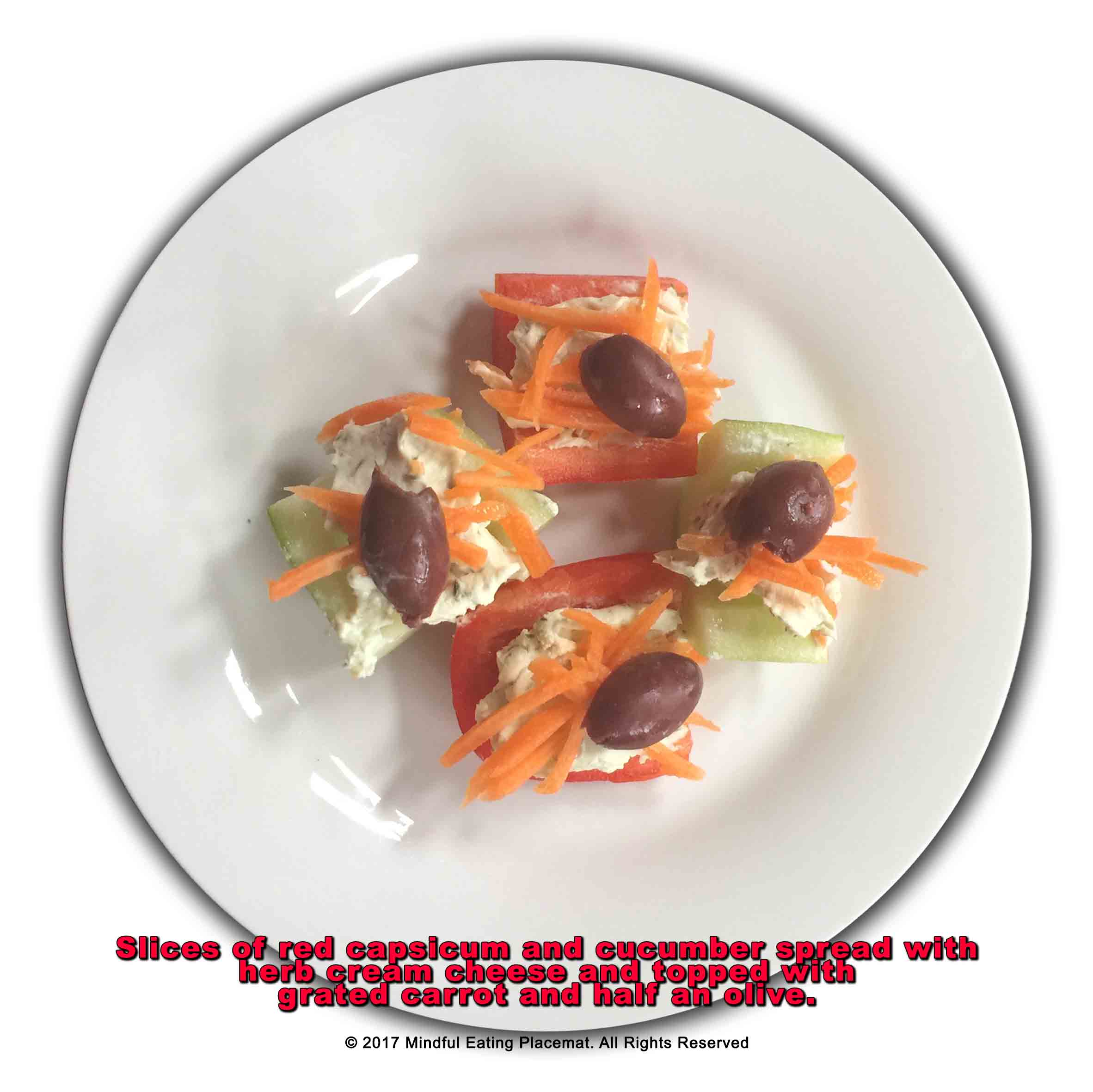 Cucumber and red capsicum slices with herb cream cheese, carrot and half an olive 